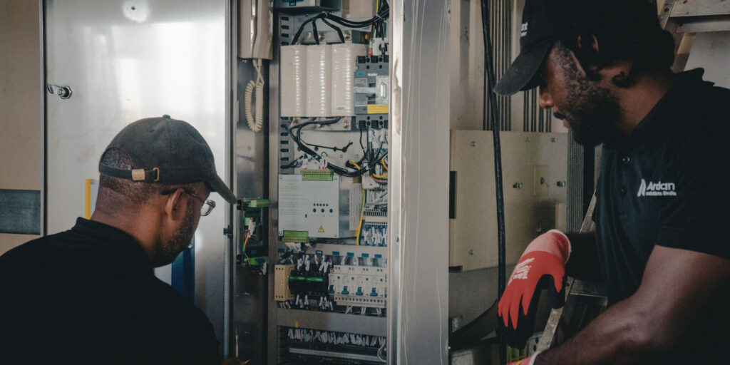 Technician performing elevator maintenance for improved safety and durability